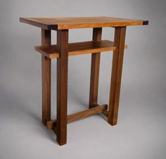 a wooden table sitting on top of a gray floor