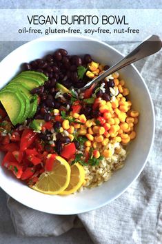 a bowl filled with rice, beans and avocado on top of a table