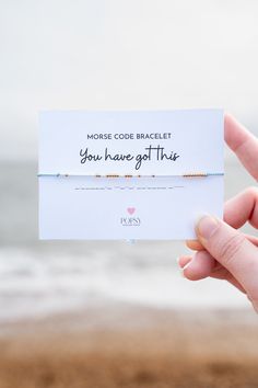 someone holding up a card that says, more code bracelet you have got this