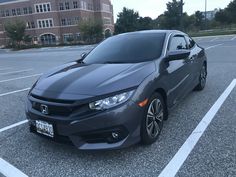 a gray car parked in a parking lot