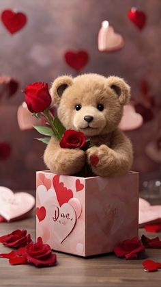 a teddy bear sitting on top of a valentine's box with roses in it