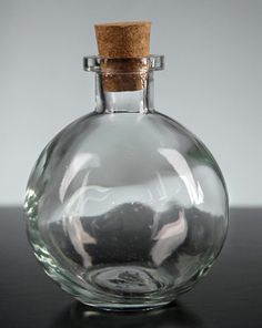 an empty glass bottle with a cork top