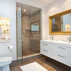 a bathroom with a toilet, sink, and shower stall in it's center