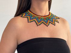 These magnificent necklaces come from the Embera indigenous community and are created with great mastery. They come from the Choco province on the Colombian Pacific coast and represent a point of convergence between European, African and Amerindian culture.  Of these handmade pieces, not two are alike. Each purchase helps empower these masterful artisans. Artisan Multicolor Boho Collar Necklace, Southwestern Style Fair Trade Festival Jewelry, Artisan Beaded Necklaces With Boho Collar For Festivals, Multicolor Handwoven Southwestern Necklaces, Southwestern Handwoven Festival Jewelry, Southwestern Style Handwoven Multicolor Necklaces, Southwestern Handwoven Jewelry For Festivals, Southwestern Style Multicolor Handwoven Necklace, Adjustable Southwestern Style Handwoven Necklace