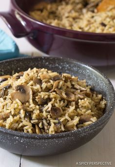 a bowl filled with rice and mushrooms on top of a table