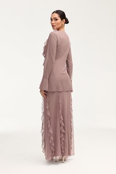 Indulge in the exquisite elegance of the Adriana Waterfall Mesh Maxi Skirt in Twilight Mauve. Crafted from delicate mesh fabric, this skirt features a cascading waterfall ruffle detail and flattering princess seams. Perfect for making a sophisticated statement at any event or occasion. Model is 5'7" and is wearing size S/44". Please note this garment runs tight. We kindly recommend choosing one size up from your usual size. Feminine Chiffon Ruffle Skirt, Feminine Chiffon Skirt With Ruffles, Flowy Party Skirt With Ruffles, Feminine Ruffled Evening Skirt, Elegant Party Skirt With Ruffle Hem, Elegant Long Sheer Dress, Elegant Fitted Skirt With Layered Hem, Chic Wedding Skirt With Ruffles, Elegant Skirt With Ruffles