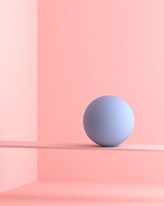 a blue ball sitting on top of a shelf in front of a pink wall and floor