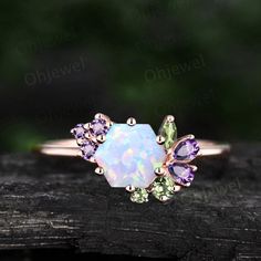 "This is a Hexagon 6x6mm  1ct Lab treated opal engagement ring in solid gold,  The accent stones are natural peridot and amethyst. The band width is about 1.4mm. It can be made in any ring size. However please contact me to custom make it to a special big or small size. It can be made in white gold,rose gold or yellow gold with 14k or 18k. However for some people who are nickel allergic,I can also make it to 925 sterling silver to make you can wear it. The ring is handmade,very high quality! 30 days money back guarantee. Returns & Warranty 30-Day money back guarantee (starting from the day of delivery). \"Made to Order\" purchases qualify for our 30-day money back guarantee. The 30-day money back guarantee gives you time to make sure your purchase is perfect. If you need to  return it for Opal Ring Unique, Opal And Amethyst Ring Engagement, Unusual Wedding Rings Women, Opal Cluster Ring, Lilac Jewelry, Engament Rings, White Opal Engagement Ring, Opal Engagement Ring Rose Gold, Unique Opal Ring