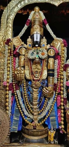 the statue is decorated with gold and blue decorations