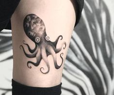 an octopus tattoo on the right arm and shoulder is shown in black and grey ink