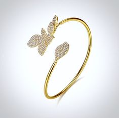 This delightfully unique bridal bangle bracelet is very much in vogue! Studded with flawlessly faceted cubic zirconia that captures the light from every angle with a perfectly translucent appeal, the bracelet is rhodium / rose gold / yellow gold plated for a flawless finish which perfectly enhances the intricate detailing and conveys a modern take on old elegance. The bracelet measures 7" (approx. 17.8cm) in circumference, with the open design making it adjustable to accommodate a large range of Cubic Zirconia Gold Bangle Bracelet For Party, Dazzling Cubic Zirconia Gold Bangle Bracelet, Party Gold Bangle Bracelet With Cubic Zirconia, Adjustable Cubic Zirconia Cuff Bangle Bracelet, Elegant Adjustable Crystal Bangle, Adjustable Crystal Bangle Elegant Style, Adjustable Elegant Crystal Bangle, Adjustable Cubic Zirconia Bangle With Diamond Accents, Adjustable Bangle With Diamond Accents In Cubic Zirconia