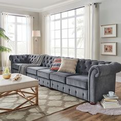 a living room filled with furniture and windows