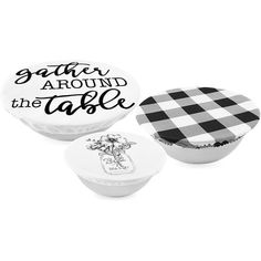 two round boxes with black and white designs on them, one has a gingham around the table