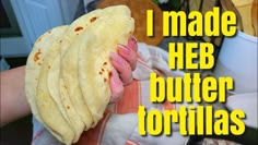 a person holding a tortilla in their hand with the words i made heb butter tortillas