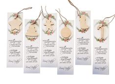 four wooden christmas ornaments hanging from twine