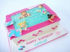 a birthday cake that is shaped like an inflatable pool with people swimming inside