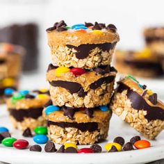 chocolate covered granola bars stacked on top of each other with m & ms in the middle