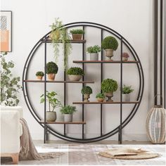 a round metal shelf with potted plants on it