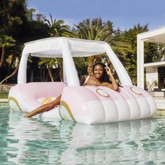 a woman laying on top of an inflatable pool float near a swimming pool