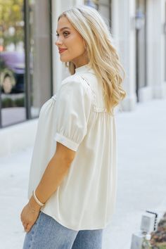 Add a touch of texture and elegance to your everyday wardrobe with the Braided Button Down Top! This effortlessly chic top blends classic design with unique boho-inspired details, making it a versatile must-have. Featuring intricate braided trim detail, this top elevates a simple look with subtle, eye-catching texture. Whether paired with jeans, skirts, or layered under a jacket, this top is the perfect blend of casual and boho chic, making it a go-to piece for any occasion. Chic Relaxed Fit Solid Color Blouse, Chic Solid Color Blouse For Day Out, Chic Flowy Button-up Top, Spring Casual Blouse With Buttons, Chic Flowy Blouse For Workwear, Spring Casual Button Blouse, Spring Casual Buttoned Blouse, Chic Blouse For Casual Gatherings, Relaxed Fit Blouse With Back Button Closure For Spring