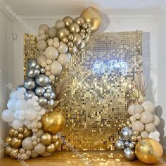 a gold and silver party decoration with balloons