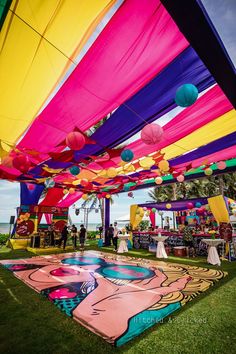 an outdoor event with colorful decorations and tables