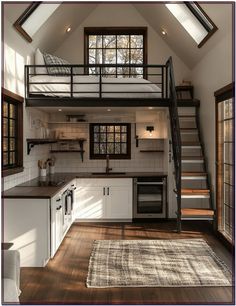 an open loft with stairs leading up to the kitchen