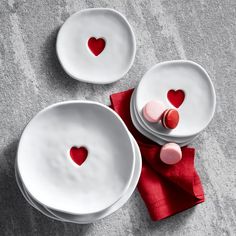 two white plates with hearts on them sitting next to each other