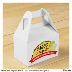 a small white box with a taco fiesta logo on it sitting on top of a wooden table