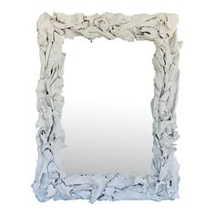 a large white mirror sitting on top of a table