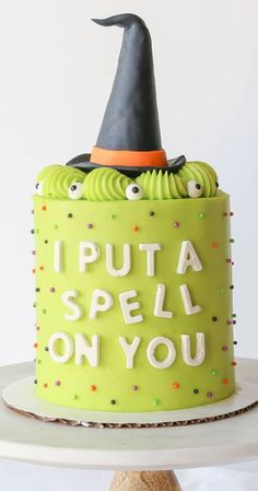 a green cake with a witch hat and i put a spell on you written on it