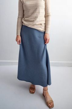 The Celine skirt will be a great addition to your practical wardrobe. The elastic waistline and graceful a-line design combine practicality and comfort. This skirt is such a calming color and the knit fabric has the timeless appeal that subtle texture gives. Style: no slit, elastic waist, maxi Fit: true to size Color: Denim Blue Fabric content: 71% Polyester, 27% Cotton, 2% Spandex Care instructions: wash gentle cycle, cold; lay flat to dry, cool iron if needed. For best results, always follow c Celine Skirt, Product Manufacturing, Stormy Blue, Working Out Outfits, Be Intentional, Knit Maxi Skirt, Workout Outfits, Modest Clothing, Garment Labels