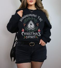 This creepy Christmas sweatshirt is perfect for everyday wear. This gothic crewneck sweater also makes the perfect gift for the witchy person in your life. ▼The fit is true to size. The model is wearing a size XL for an oversized look. If you would like an oversized fit, please order 1-3 sizes larger than your normal size. If you would like a fit that is true to your size, please view the size chart in the photos and order your normal size. ▼GILDAN 18000 UNISEX SWEATSHIRT - Medium-heavy fabric. Witchy Clothing, Goth Christmas, Elsa Shirt, Creepy Christmas, Funny Christmas Sweaters, Fall Tee, Shirt Store, Goth Outfits, Colorful Hoodies