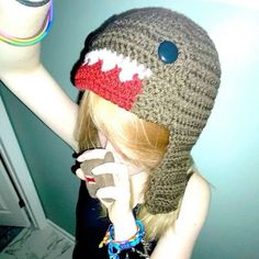 a woman wearing a knitted hat and holding a cell phone up to her ear