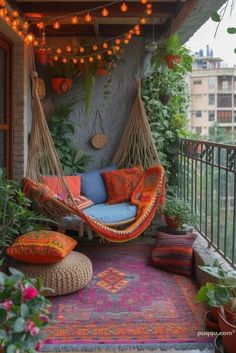 a hammock hanging from the side of a building with potted plants on it