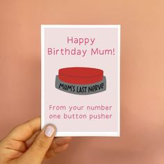 a hand holding up a card that says, happy birthday mum from your number one button pusher