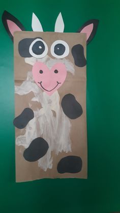 a paper bag with a cow painted on it's face and the bottom part of its body