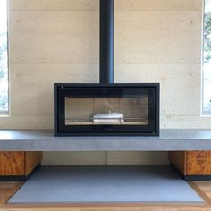 a black stove sitting on top of a cement counter