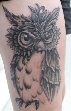 an owl tattoo is shown on the thigh