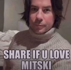 a man with long hair wearing a turtle neck sweater and text that reads, share if u love mitsk