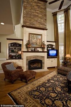 a living room filled with furniture and a flat screen tv on top of a fireplace