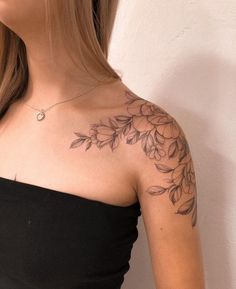 a woman with a tattoo on her shoulder