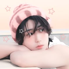 a young man with black hair wearing a pink hat and stars on his head is posing for the camera