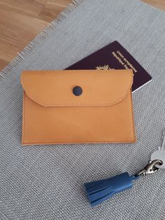 Camel leather passport holder This case is ideally designed to protect your passport, it opens easily thanks to its press button and the loop on the back will allow you to hang it on the belt. Very light and compact, it will easily be hidden under your clothes so you can travel and visit with peace of mind. This pouch is also very popular with hikers who want to travel light. Dimensions: 14.5 x 10 cm loop: 8 x 5 cm In this same color there is the matching card holder and wallet. Soelle is part of an ecological and sustainable approach, in fact the leathers used come from the end of the series from major luxury houses. Each model is unique and made in my workshop in Vendée. Quick and neat delivery You can discover all of my creations on the store and follow me on: Facebook: https://www.face Leather Envelope Card Holder For Travel, Envelope Card Holder With Interior Slots For Travel, Travel Envelope Card Holder With Interior Slots, Leather Passport Holder, Leather Card Holder, Matching Cards, Passport Cover, Travel Light, The Loop