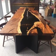 a table made out of wood with chairs around it