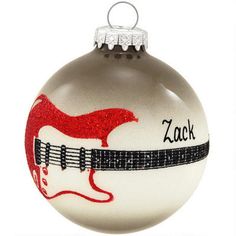 a glass ornament with a red guitar on it's neck and the name zac