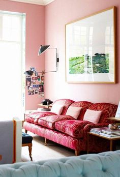 a living room with pink walls and furniture