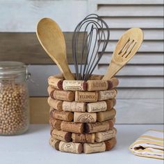 a stack of wine corks with kitchen utensils in them