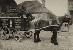 an old black and white photo of a horse pulling a wagon