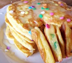 a stack of pancakes on a plate with sprinkles